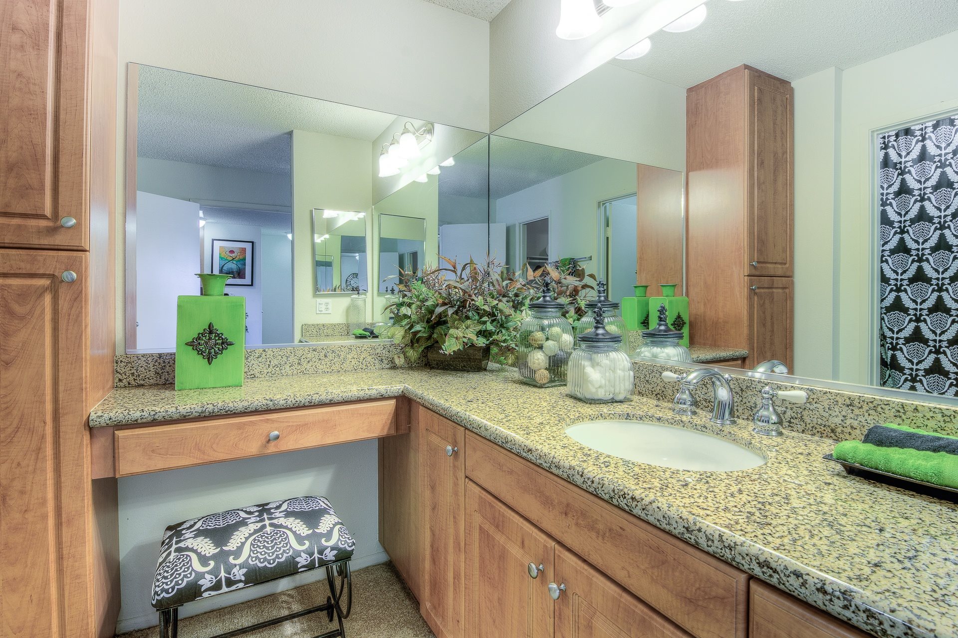 A bathroom with a green bottle on the counter.,A bathroom with a green bottle on the counter.